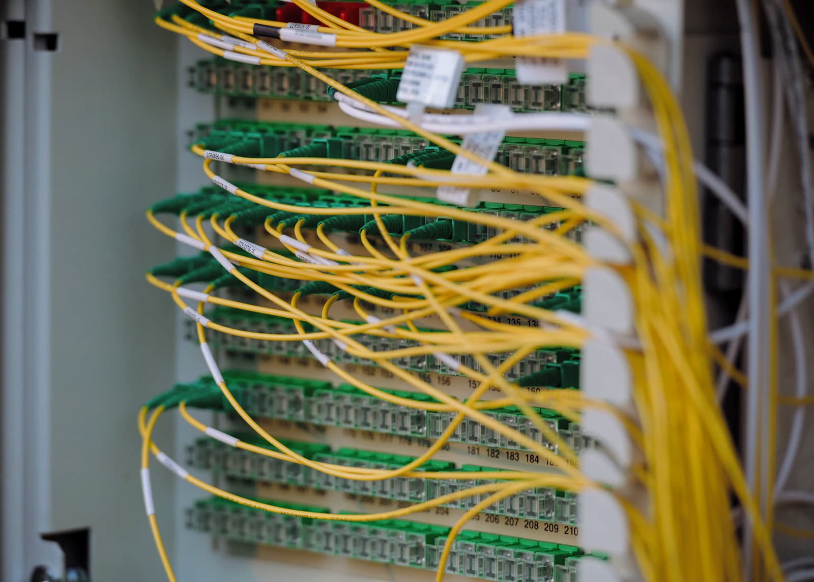 Neatly routed yellow and green network cabling in a rack